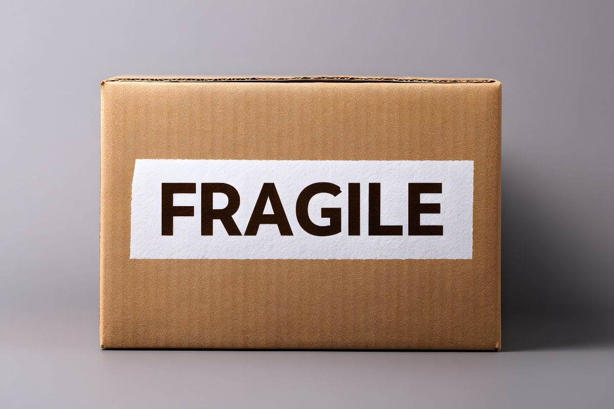 Cardboard moving box labeled fragile with bold letters