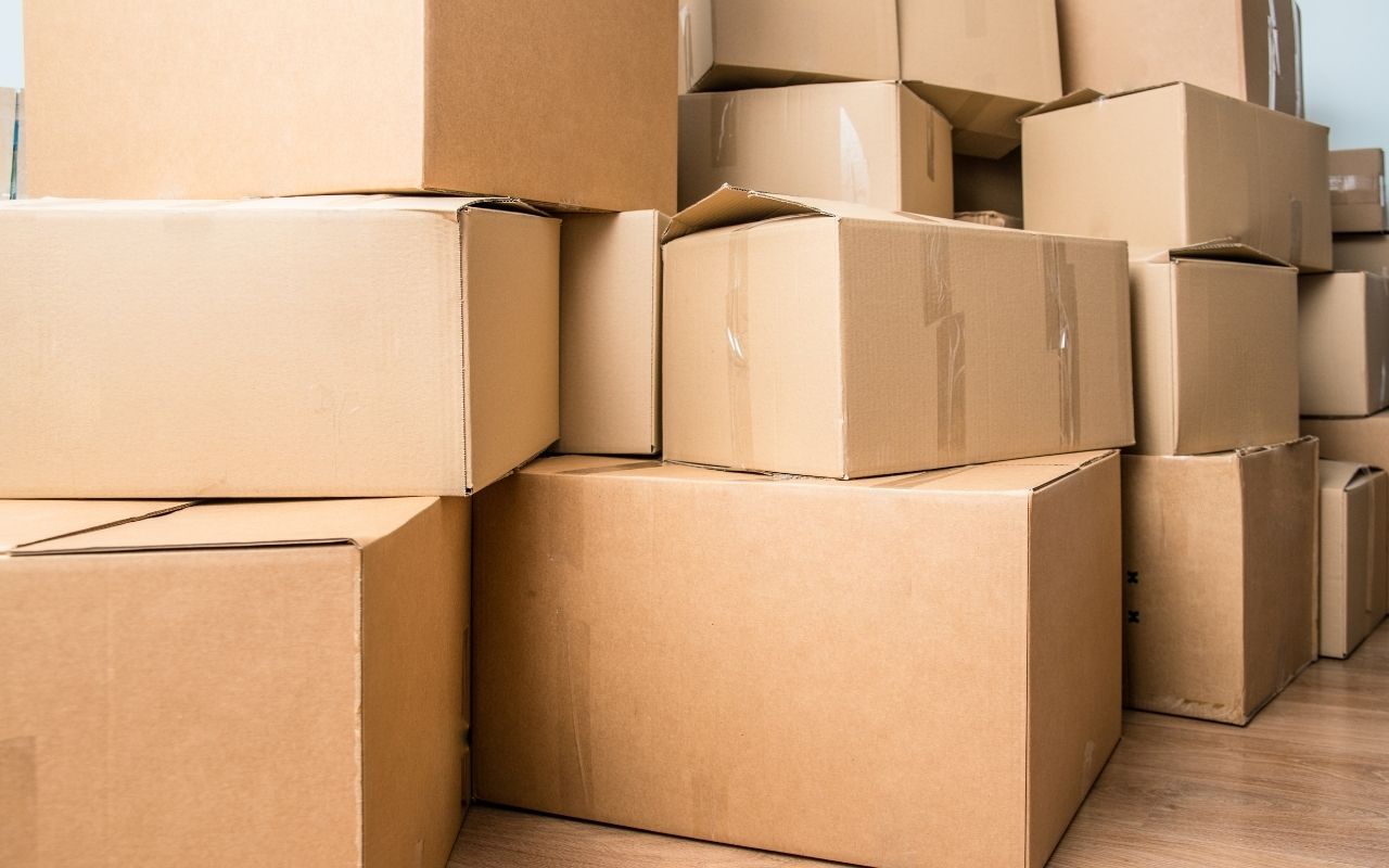 Stack of clearly labeled moving boxes in a living room