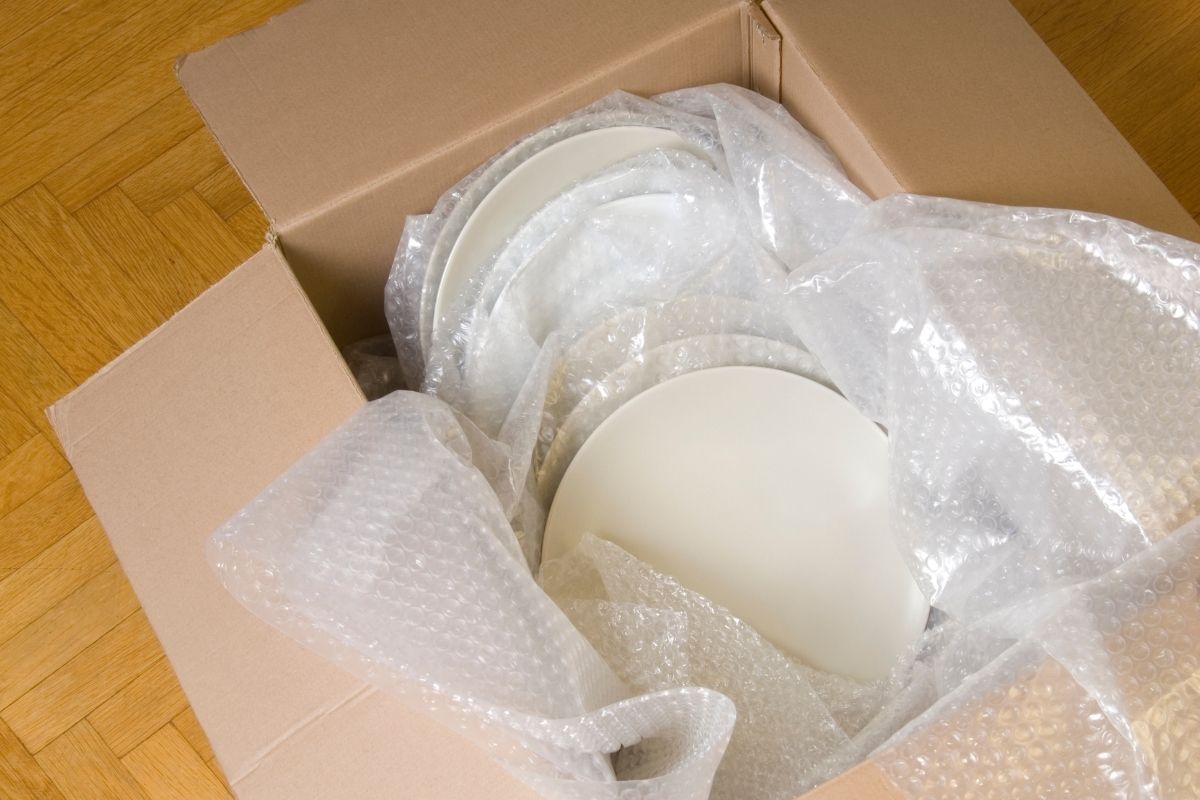 Plates individually wrapped in paper for safe moving