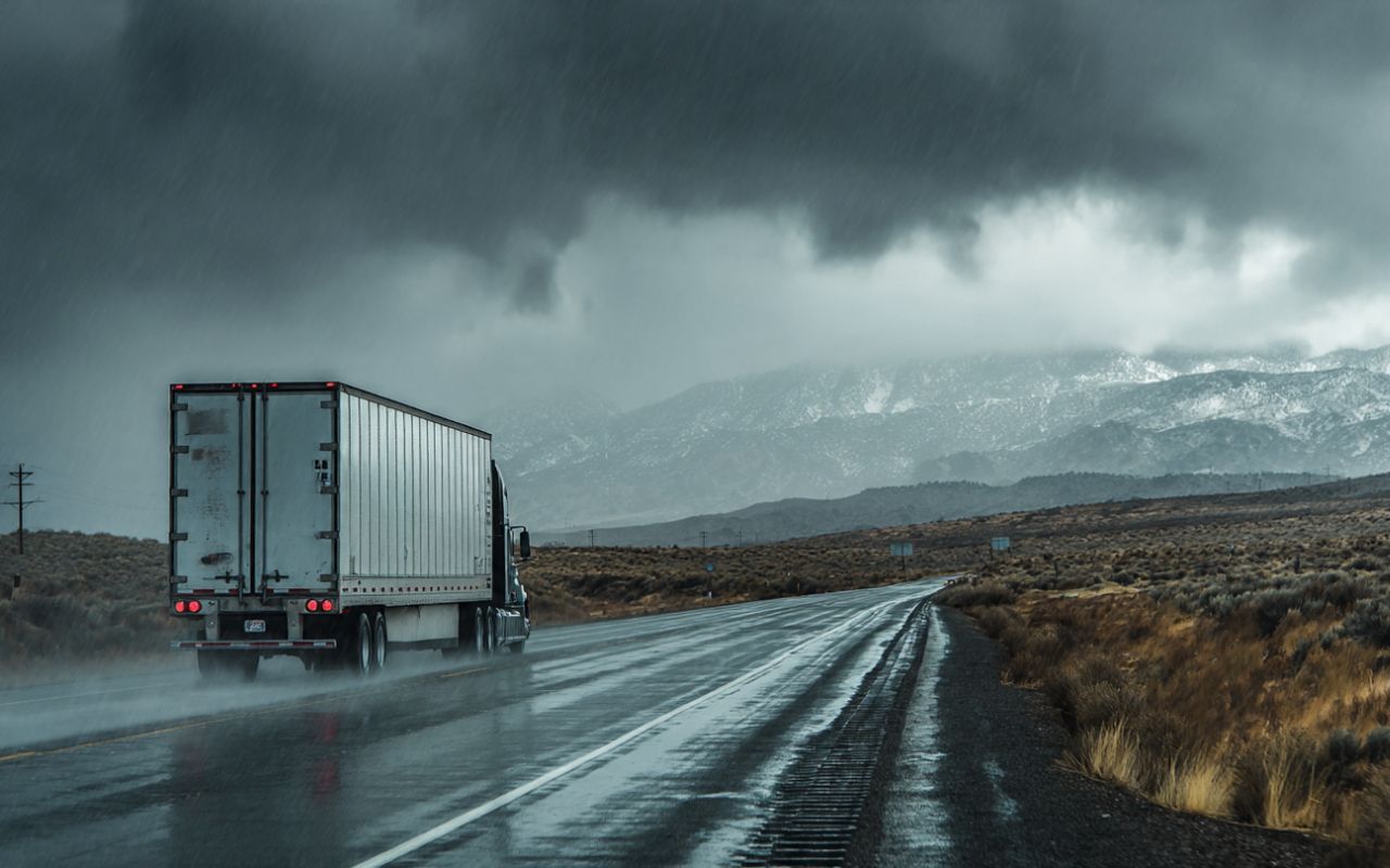 Rainy day moving tips in Bay Area with covered boxes near a truck